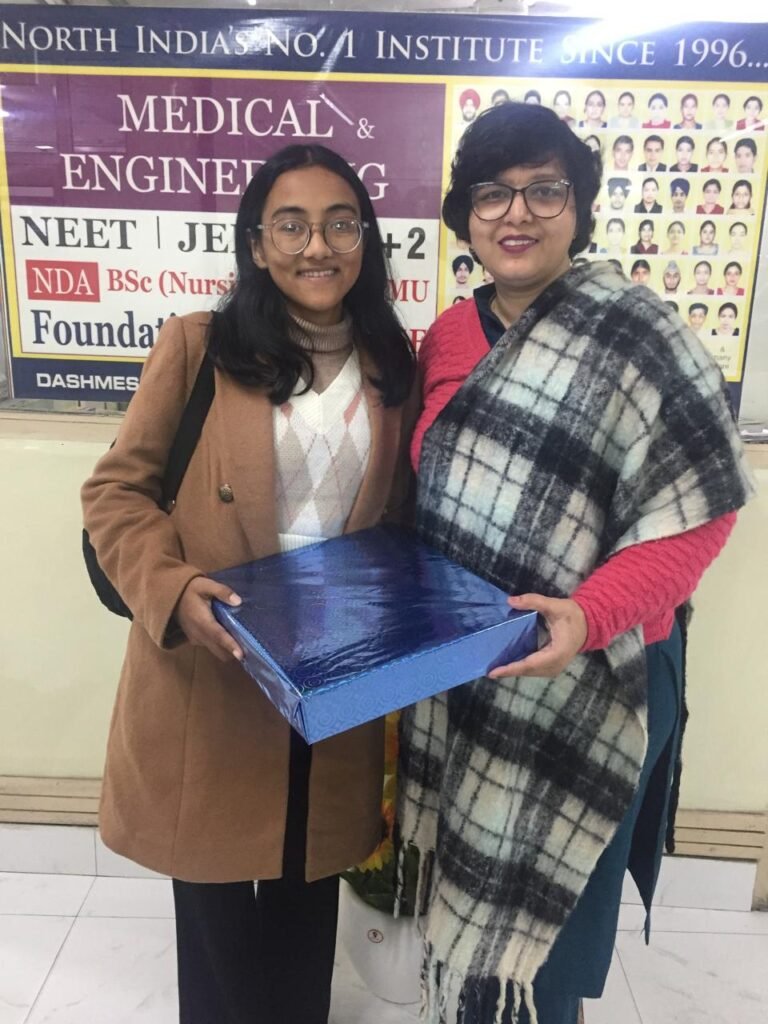 Dashmesh Academy NEET achiever being honored by faculty for exceptional performance in medical entrance exams.